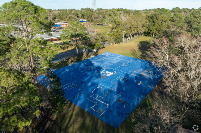 A large multipurpose court shaded by oaks gives students a break from the summer heat.