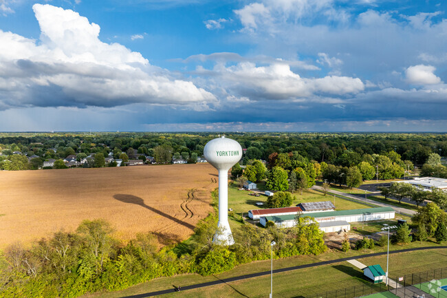 The Yorktown water tower stands proudly with nearby farm fields in the background in Yorktown, IN.