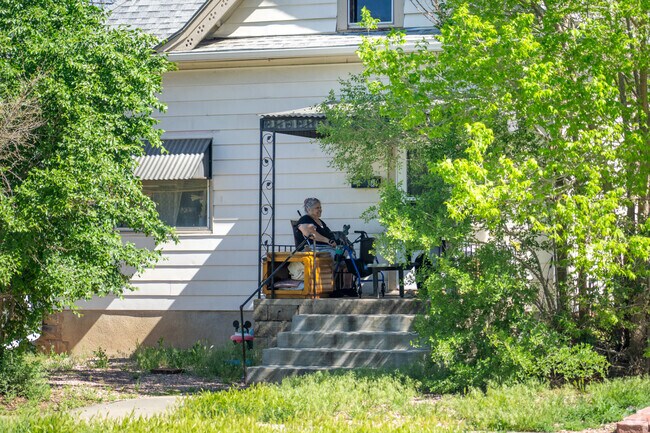 A Clayton Park resident relaxes on her porch, soaking up the sunshine and peaceful vibes of a perfect neighborhood day.