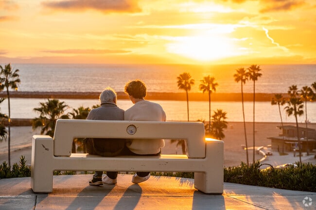 Old and young share a sunset moment at Corona del Mar State Beach Park.