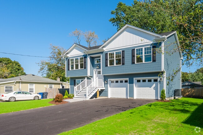 Colonials with large garages and driveways line the residential streets of Hoxie.