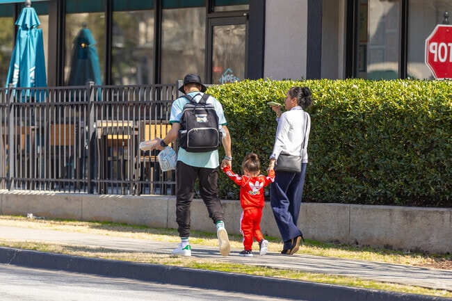 Walking with her parents in the flyest tracksuit by Adidas