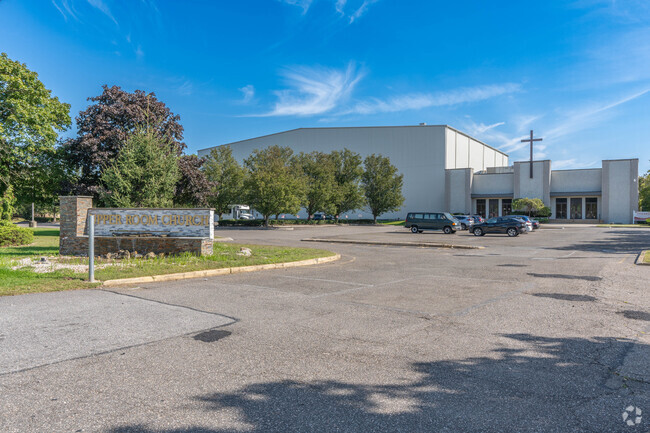 The main entrance and parking lot of Upper Room Christian School in Dix Hills.