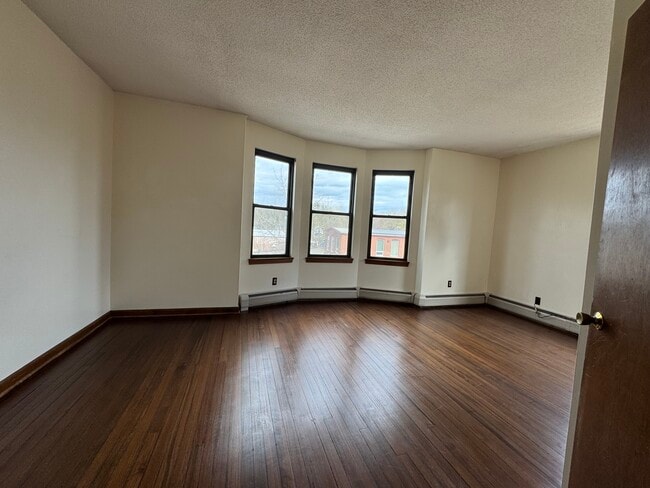 Large main bedroom with bay windows and closet