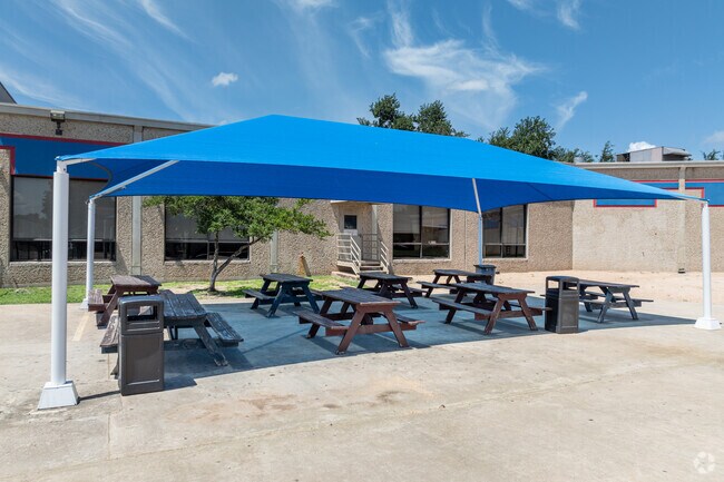 Many covered picnic benches are available for students at Harmony School of Excellence - Austin.