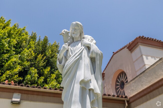 A white marble sculpture honors the parish of Transfiguration Elementary in Los Angeles, CA.