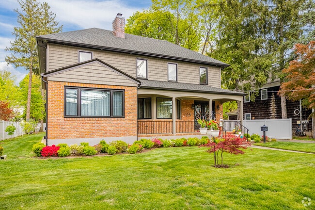 The hipped roof on this Colonial Revival in Roslyn Heights has an iconic look.