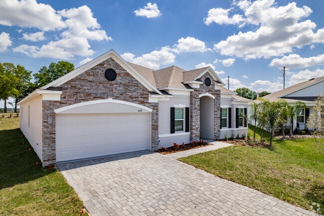 A beautiful stone faced three-bedroom craftsman bungalow in Mascotte.