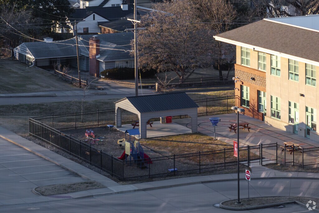 A small pavilion in a fenced yard provides outdoor learning space for students at Franklin Elementary School.