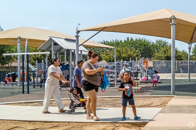 Families enjoy the playground and amenities at Inspiration Park in Fresno.
