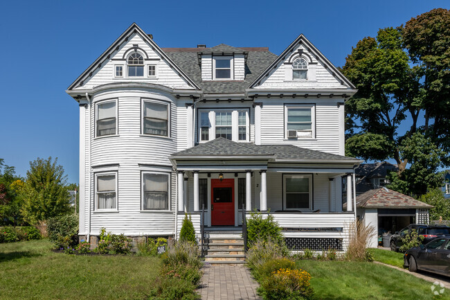 A bright red door makes a statement on this stunning white home in Saint Marks.