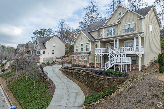 Traditional craftsman style homes sit atop hills with winding driveways.