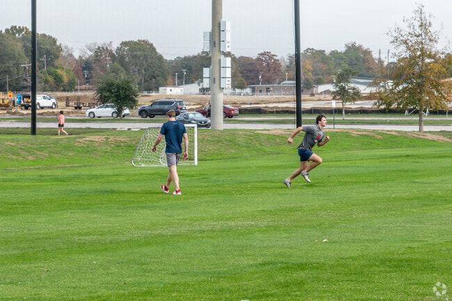 Two men train along the green space found at Youngsville Sports Complex in Youngsville.