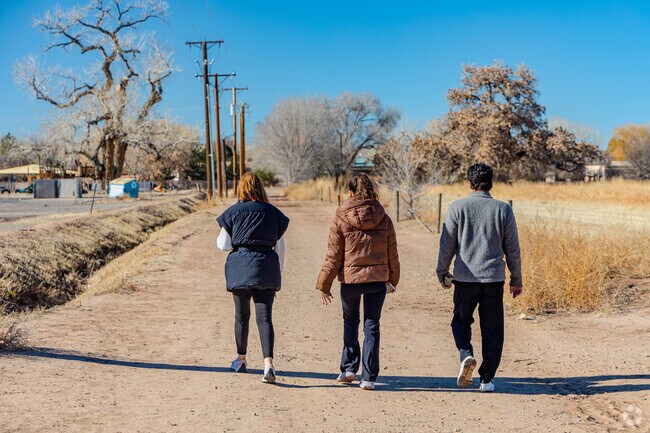 A family enjoys a walk through the Los Poblanos Open Space in the North Valley.