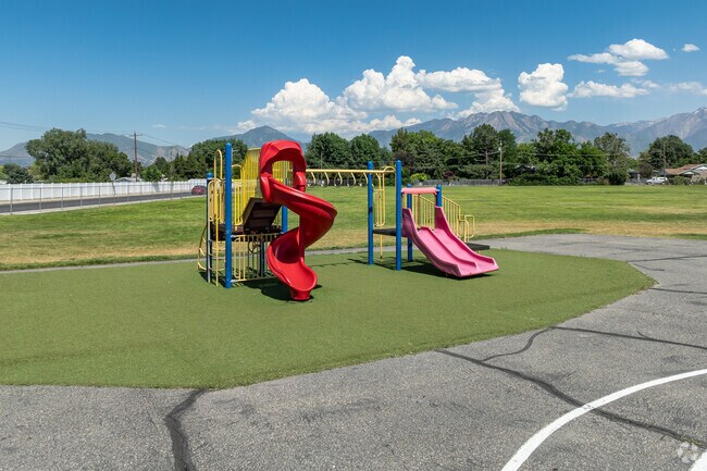 A small colorful playground at John C. Fremont Elementary School has mountain views.