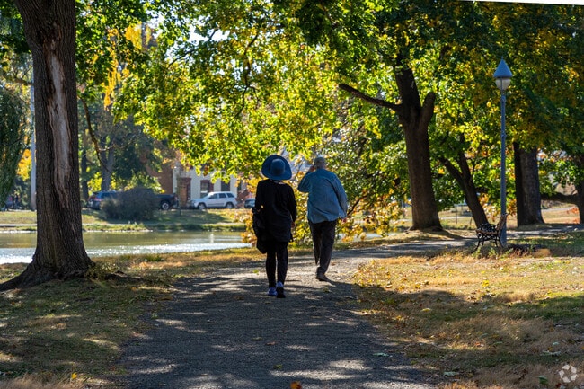Downing Park offers open lawns and reflective ponds, providing a peaceful retreat.