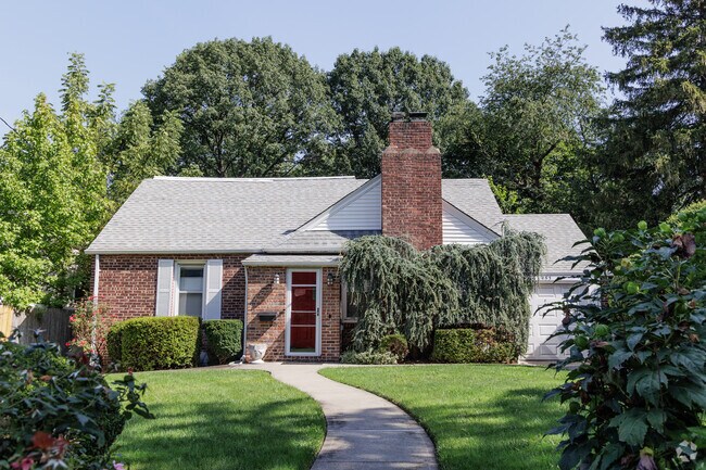 A quaint cottage home with a large yard in Leonia.