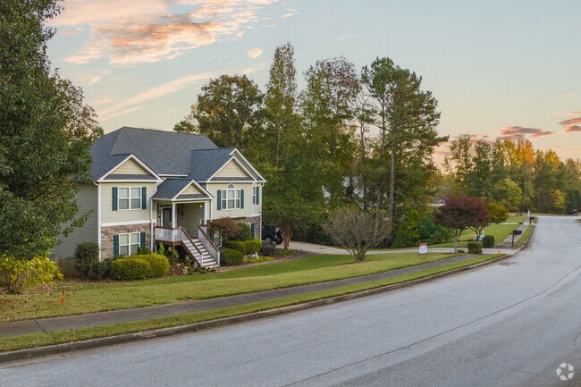 Split-level dwellings with natural tree borders between lots line the streets of Winston.