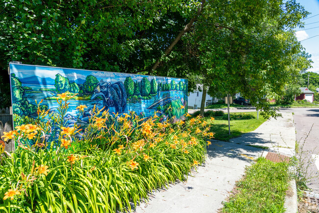 A mural of the Winooski River is painted on a fence highlighting Riversides' history.
