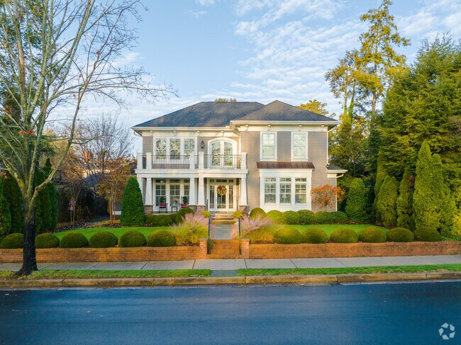 Traditional homes sit on well-manicured lawns in Byrd Park.
