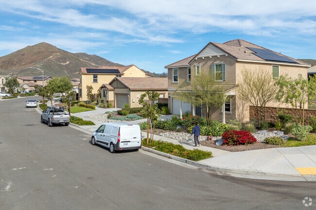 Multi-story homes line Sunnyslope streets with views of rocky hills and eucalyptus trees.