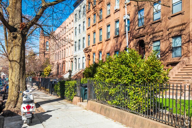Residential streets in Carroll Gardens are lined with brick rowhomes.