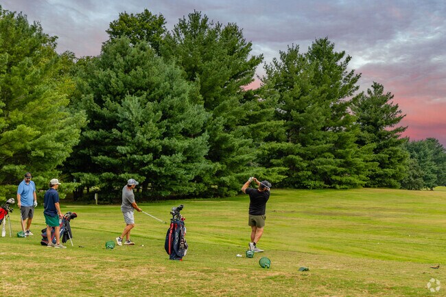 Golfers can practice their swing at Eastland Green Golf Course near Apple Hollow.