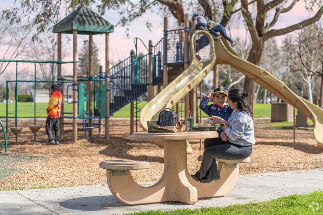 A mom and her son enjoy lunch after school at Houge Park nearby Kooser.