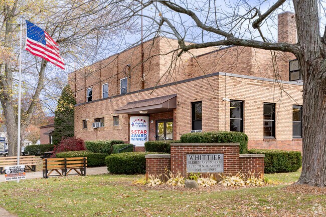 An American flag waves at the entrance to Whittier Elementary School.