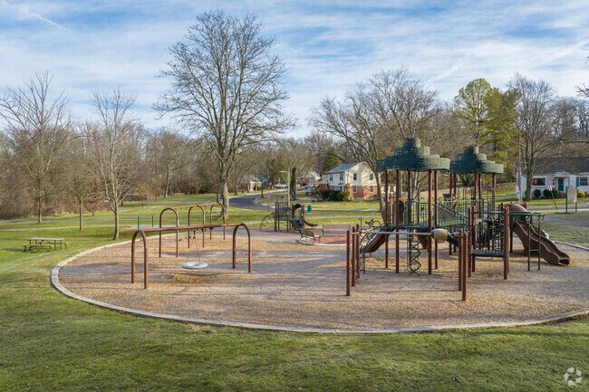 The Sudrook Park Playground near Lochearn features multiple play structures and a tire swing.