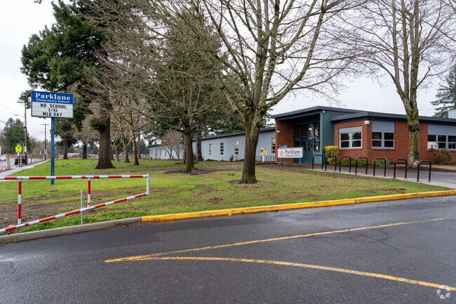 Campus signage sits in front of the teacher and parent parking lot.