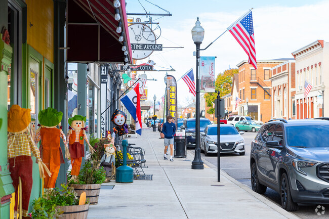 Main street in the center of Aurora neighborhood has many flags and signs to attract visitors.