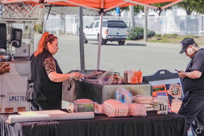 Locals in Nehyam savor churros and other snacks from nearby vendors.