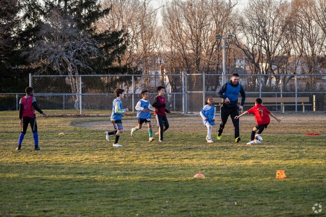 Soccer coach training young kids at Doric Park in Forest Hills, Cranston.