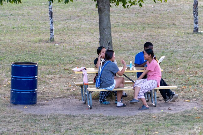 Families gather for picnics under the shady trees in Liberty Park.