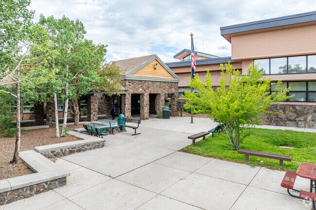 Flagstaff High School entrance with the flag waving high.
