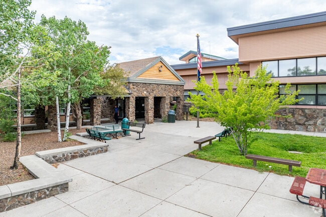 Flagstaff High School entrance with the flag waving high.