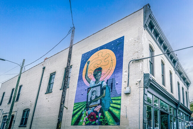 A vivid mural celebrates Black entrepreneurship and community pride.