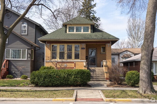Brick bungalow's withl large windows stand out on the streets of Forest Park.