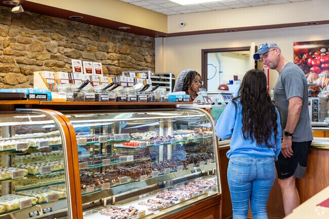 Local businesses line Kansas Avenue, including specialty shops like Hazel Hill Chocolate.