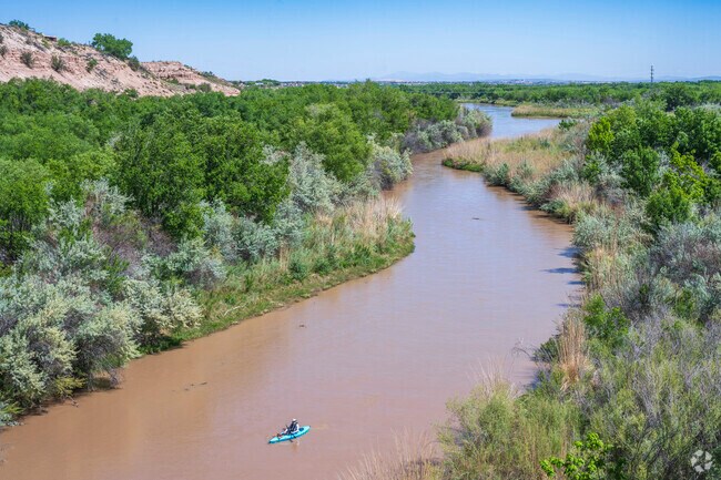A kayaker paddles down the Rio Grande near West Mesa.