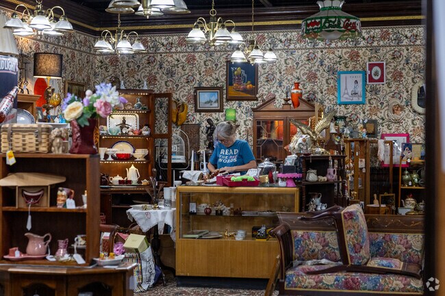 A shopkeeper tends to treasures inside a Hartville antique and thrift store.