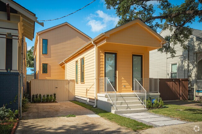 A bright orange camelback home makes an appearance on the streets of Algiers Point.