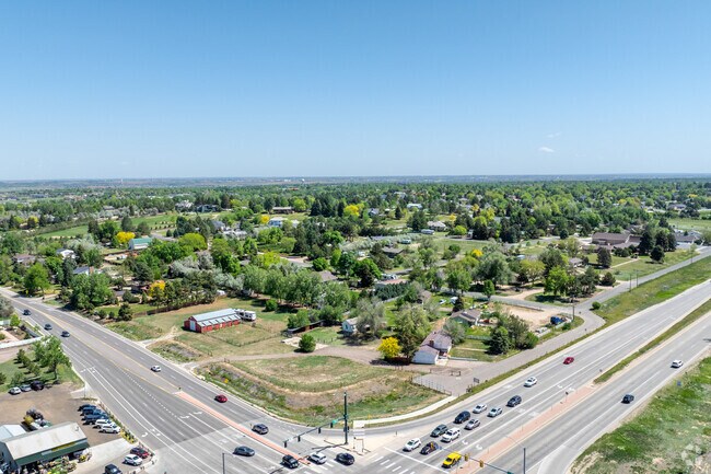 A captivating aerial perspective of Westridge in Greeley, CO, reveals its expansive lots, tranquil streets, and scenic mountain vistas, offering a serene suburban lifestyle near city conveniences.
