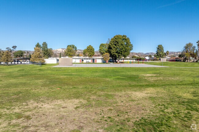 There is a lot of grass areas around Sycamore Elementary School.