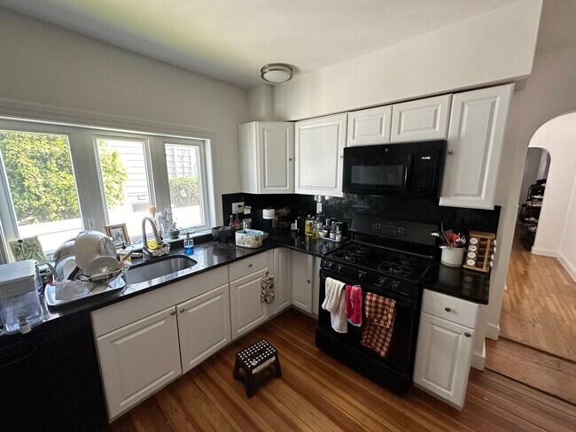Updated kitchen. All stainless steel appliances, Brazilian granite countertop, shaker cabinets.