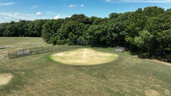 The William T. Rogers Middle School baseball field is surrounded by forestry.