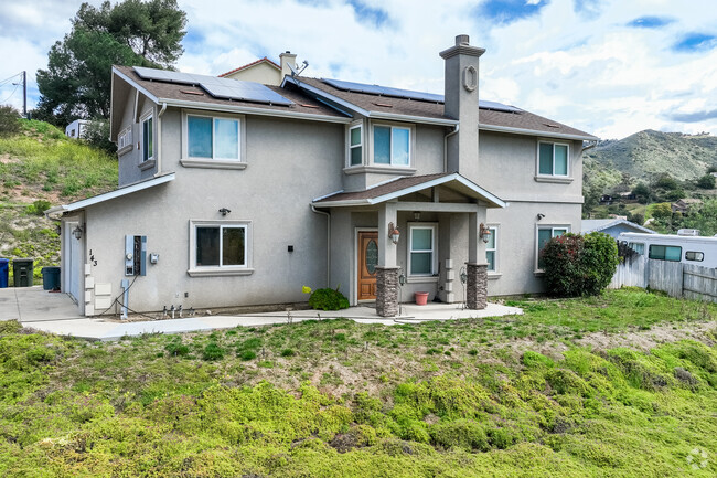 Newer stucco homes mix with many homes from 1930's in Harbison Canyon.