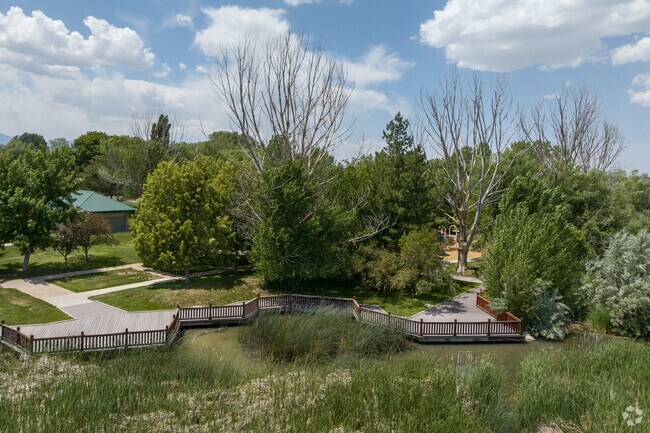 A boardwalk skirts the pond at Big Cottonwood Regional Park’s Holladay Lions area.
