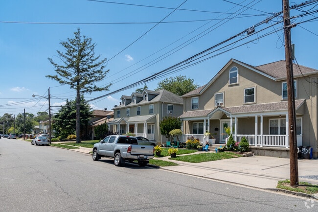 A row of colonial revival homes with well manicured lawns is found in New Cassel.